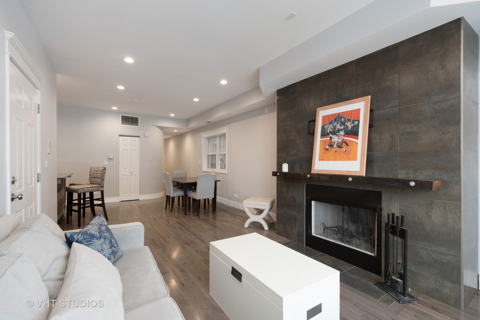 1048 West Fulton Market, Unit 3 Chicago, IL 60607 - Photo 3 of 16 a living room with furniture a flat screen tv and a fireplace
