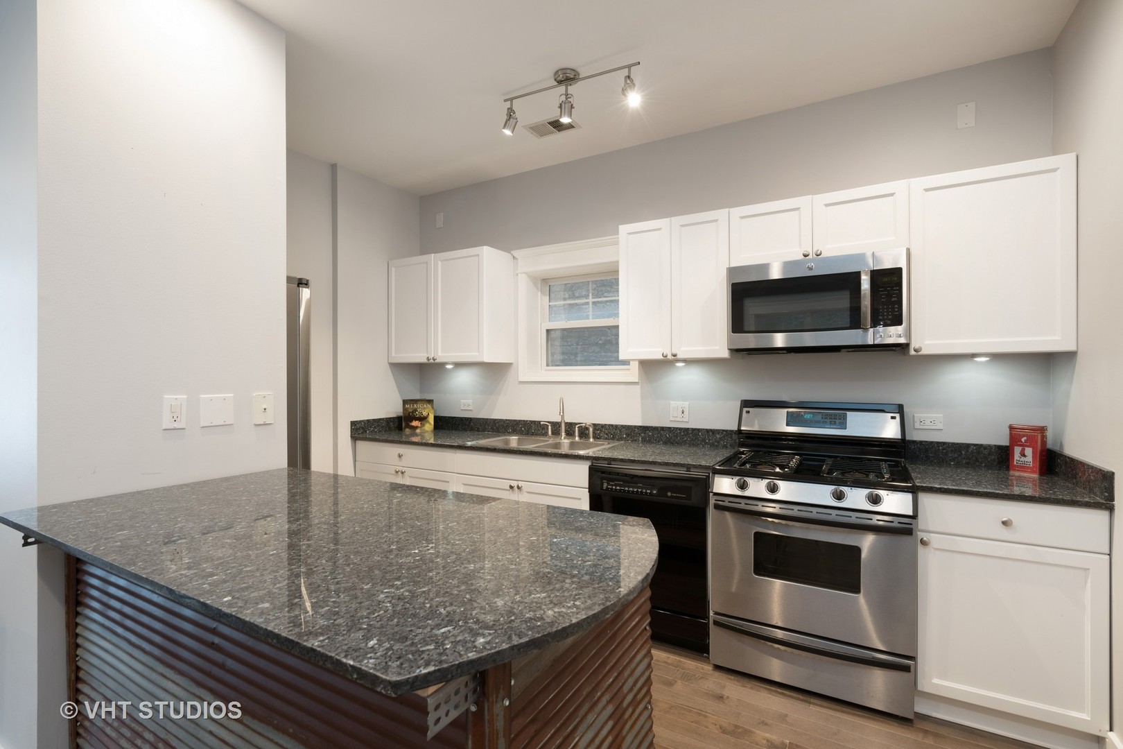 1048 West Fulton Market, Unit 3 Chicago, IL 60607 - Photo 5 of 16 a kitchen with stainless steel appliances granite countertop a stove microwave and sink