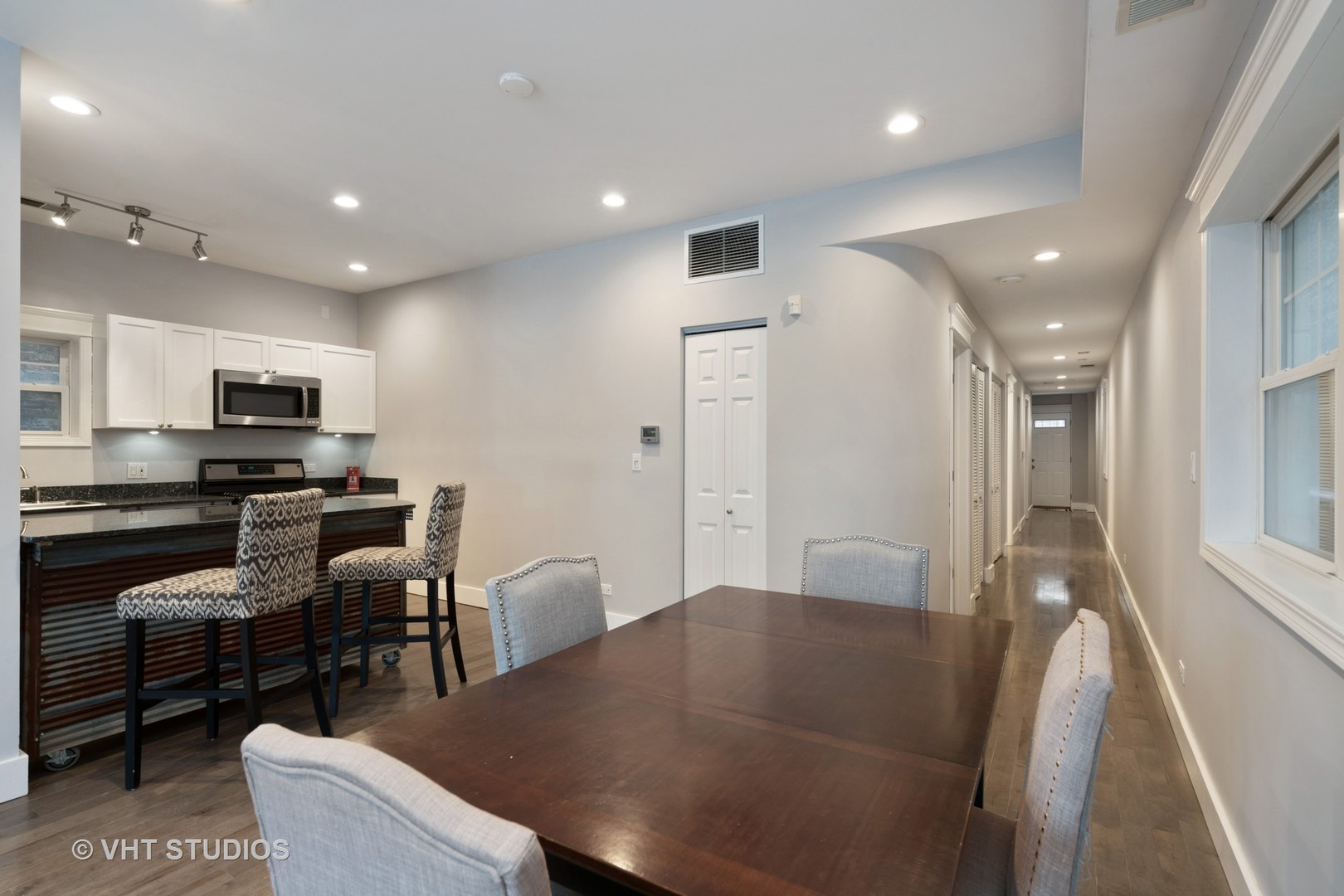 1048 West Fulton Market, Unit 3 Chicago, IL 60607 - Photo 7 of 16 a kitchen with a table chairs refrigerator and microwave