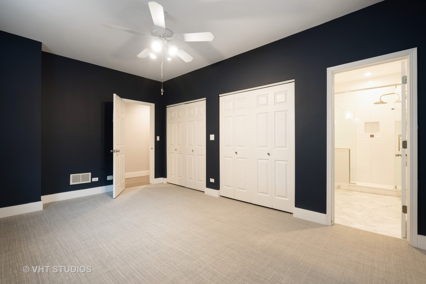 1048 West Fulton Market, Unit 3 Chicago, IL 60607 - Photo 9 of 16 an empty room with windows and chandelier fan