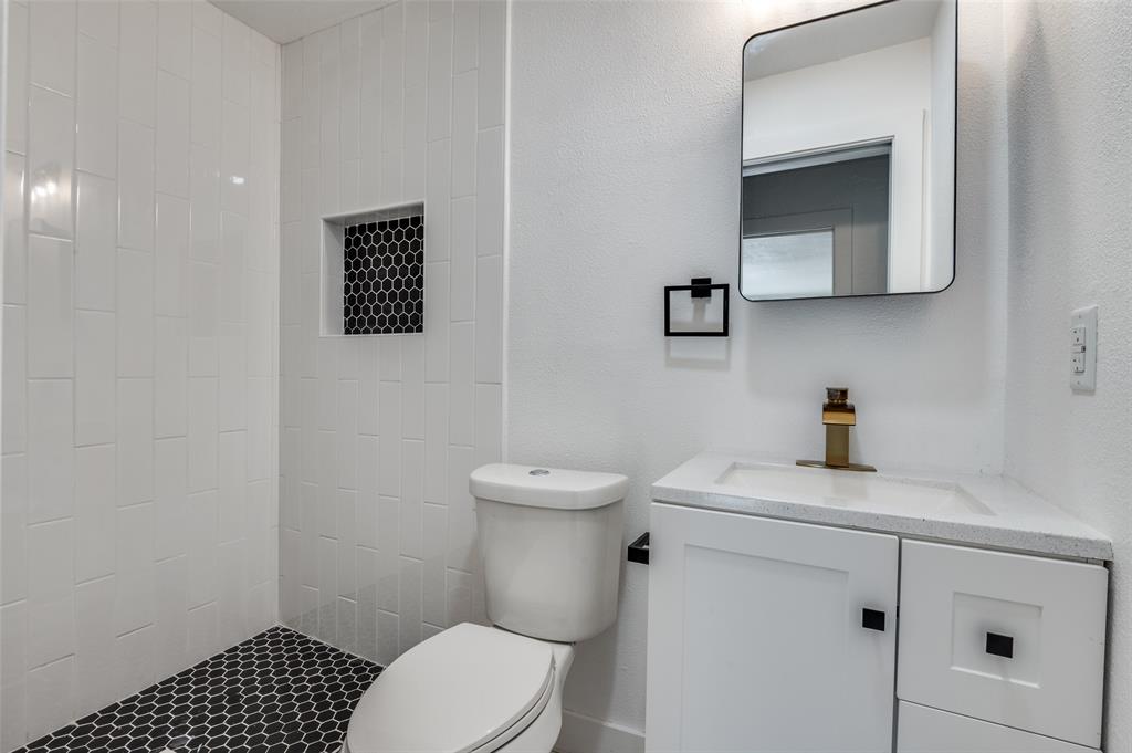 927 South Franklin Street Dallas, TX 75211 - Photo 10 of 22 a bathroom with a toilet a sink and mirror