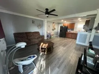 a living room with furniture and a wooden floor