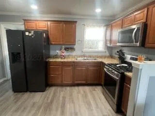 a kitchen with a sink stove and refrigerator