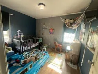 a bedroom with furniture and a window