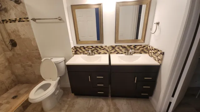 a bathroom with a toilet sink and mirror