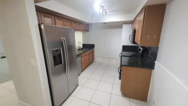 a kitchen with stainless steel appliances a refrigerator and a stove