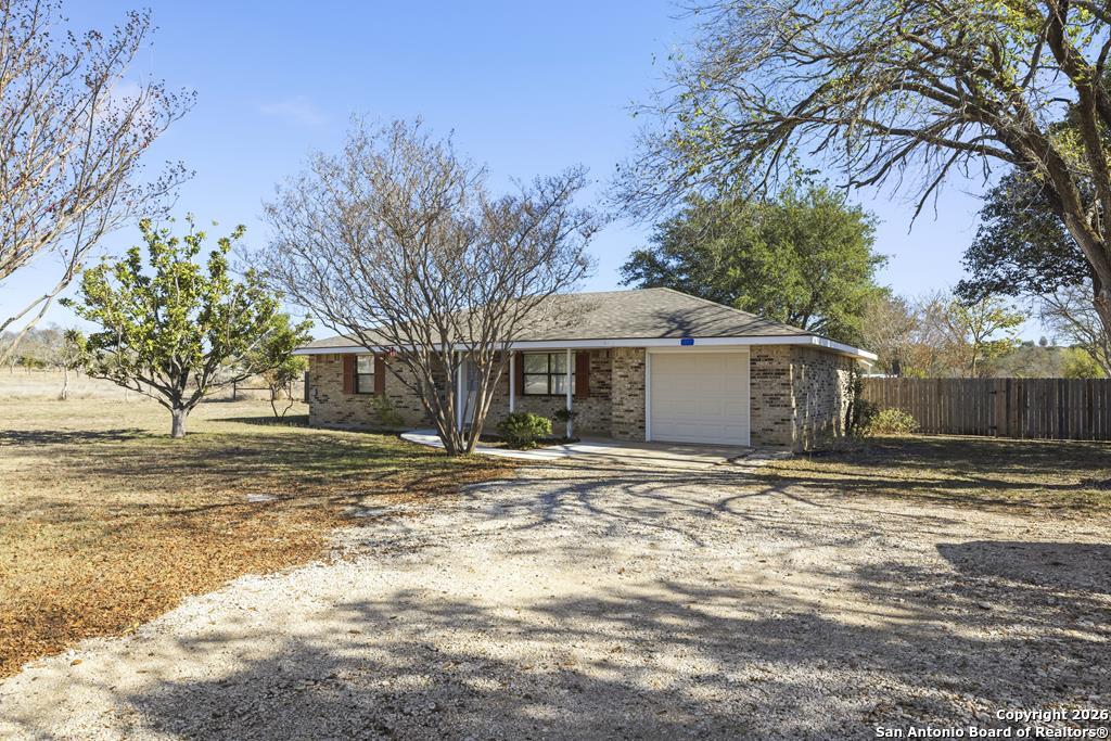 341 Stoneleigh Road Center Point, TX 78010 - Photo 1 of 18 a view of a yard with a large tree