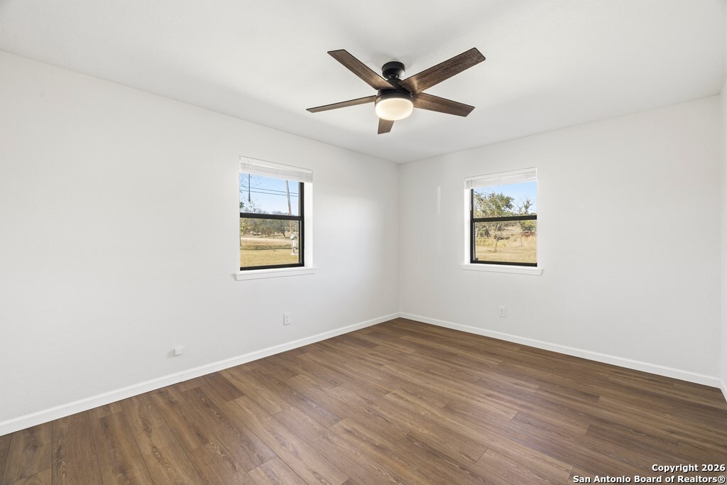 341 Stoneleigh Road Center Point, TX 78010 - Photo 11 of 18 a view of a big room with wooden floor closet and windows