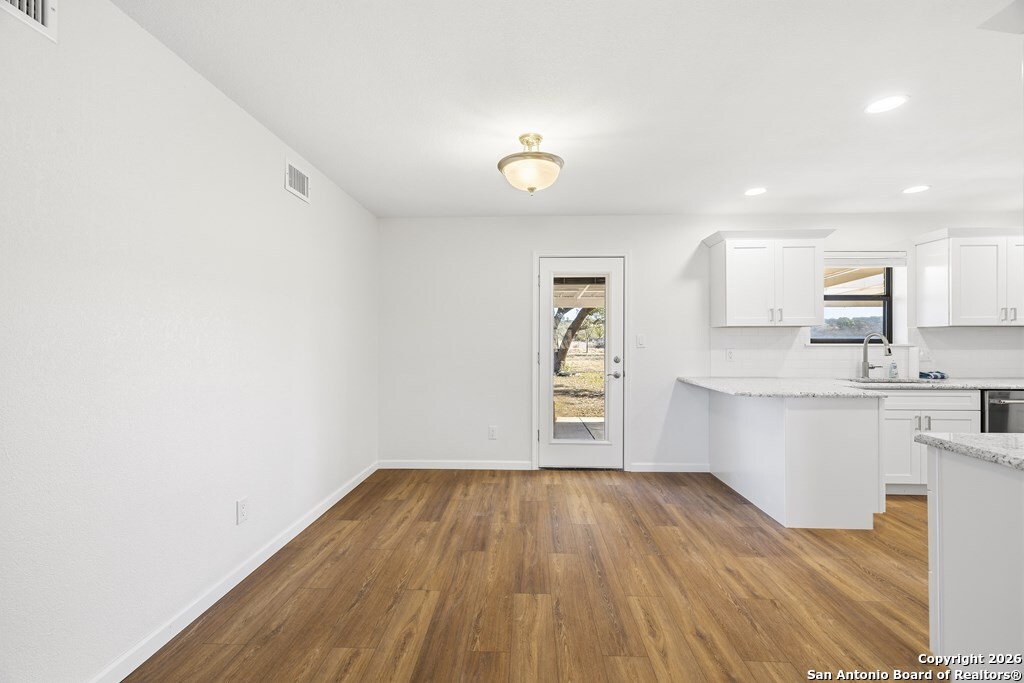 341 Stoneleigh Road Center Point, TX 78010 - Photo 4 of 18 a view of kitchen with wooden floor and electronic appliances