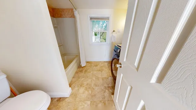a living room with furniture rug and wooden floor