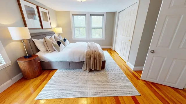 a bedroom with a bed couch and a window