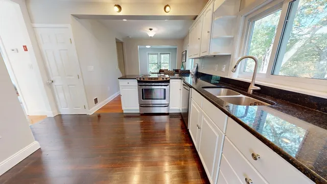 a kitchen with granite countertop a stove and a sink