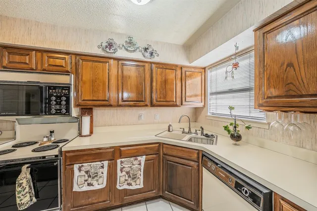 a kitchen with stainless steel appliances granite countertop a sink and cabinets