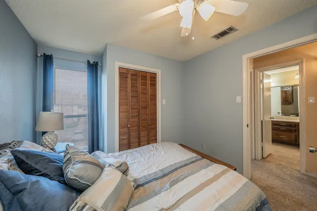 a bedroom with bed and window