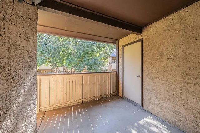 a view of a door and wooden floor