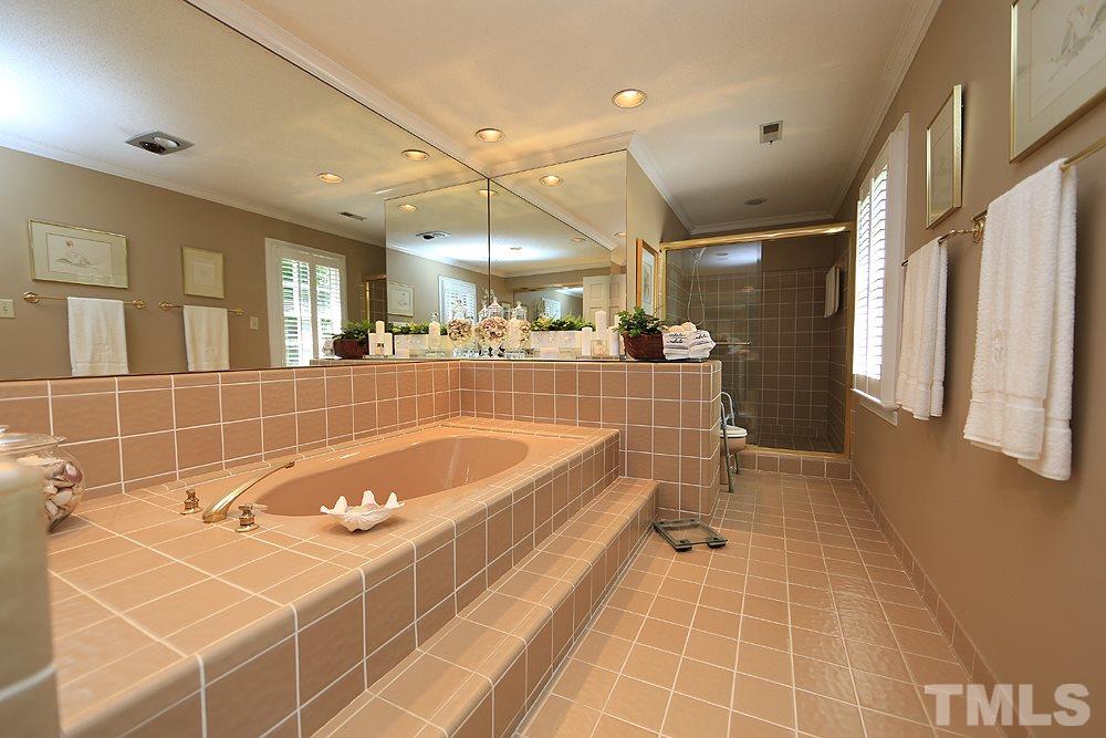 2308 Legacy Court Raleigh, NC 27615 - Photo 17 of 25 a bathroom with a tub a sink and a shower