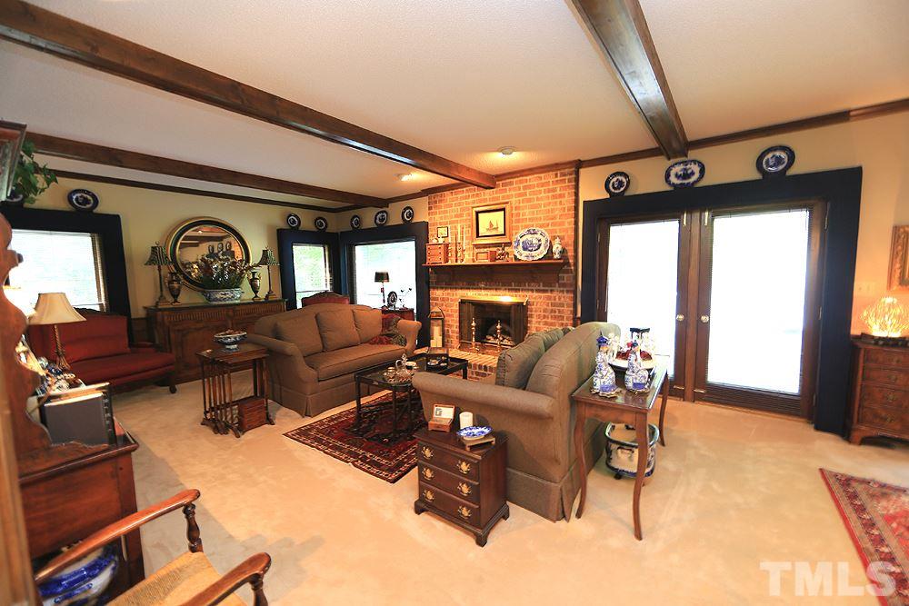 2308 Legacy Court Raleigh, NC 27615 - Photo 6 of 25 a living room with fireplace furniture and a large window
