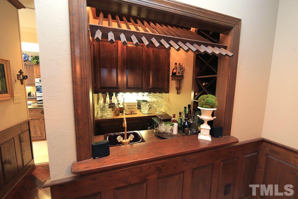 2308 Legacy Court Raleigh, NC 27615 - Photo 8 of 25 a room with a chair a mirror and potted plant
