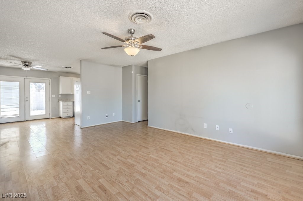 3948 Maple Hill Road Las Vegas, NV 89115 - Photo 6 of 20 Spare room with light wood finished floors, visible vents, a textured ceiling, and ceiling fan