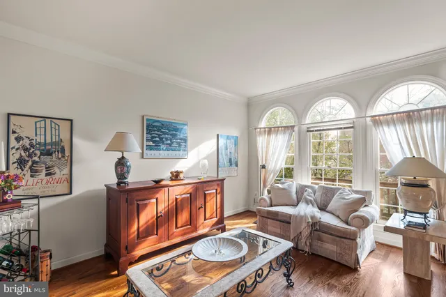 a living room with furniture a fireplace and a large window