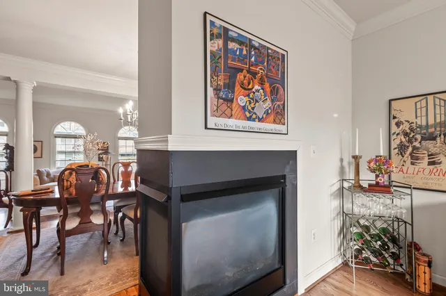 a living room with furniture a dining table and paintings on the wall