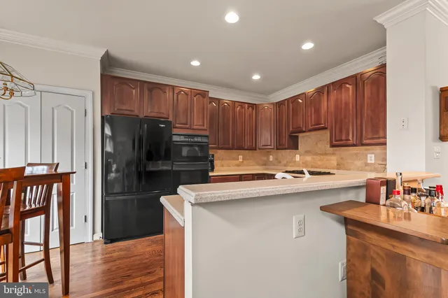 a kitchen with kitchen island a sink stainless steel appliances and cabinets
