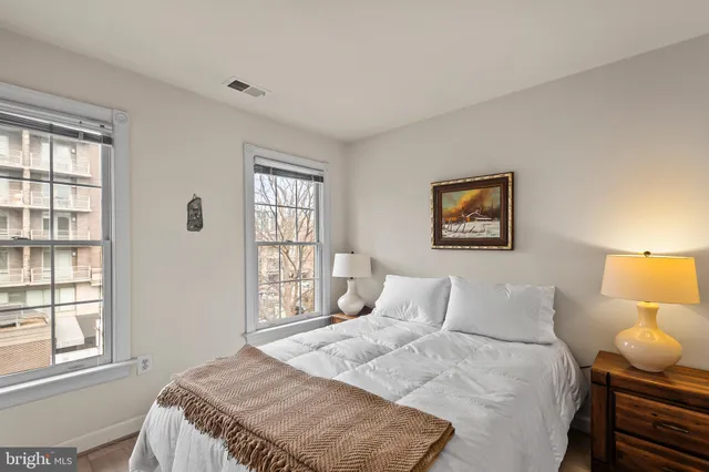 a bedroom with a bed and a window