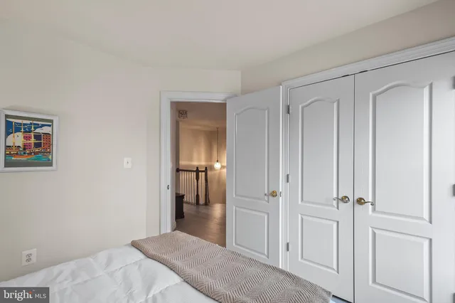 a bedroom with a bed and hallway