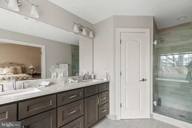 a bathroom with double sink and a mirror