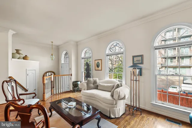 a living room with furniture a window and a table