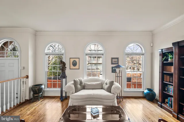 a living room with furniture and a floor to ceiling window