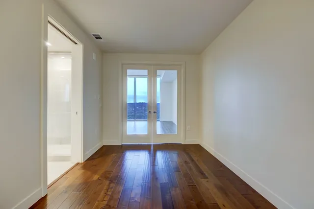 wooden floor in an empty room with a window