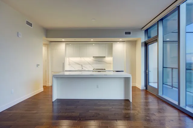 a room with wooden floor and cabinets