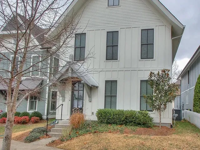 a patio with couches table and chairs and potted plants
