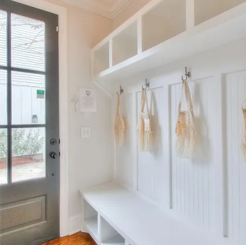 a view of a patio with couches and a table and chairs with wooden floor