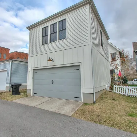 a backyard of a house with table and chairs