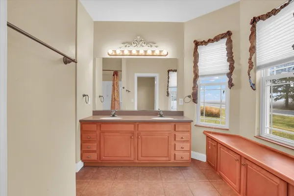 a large bathroom with a large tub and sink