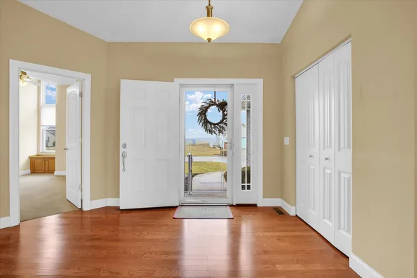 a view of an entryway with wooden floor