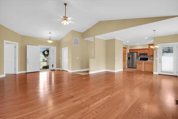 a view of empty room with wooden floor