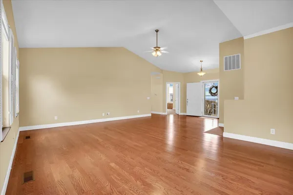 wooden floor in an empty room with a window