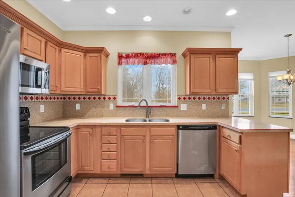 a kitchen with stainless steel appliances granite countertop a sink stove and cabinets