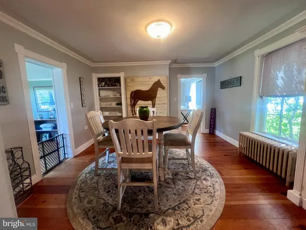 a dining room with furniture a rug and wooden floor