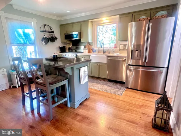 a kitchen with a sink appliances and cabinets