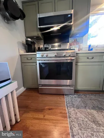 a stove top oven sitting inside of a kitchen