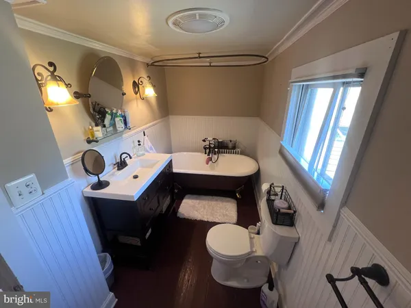 a bathroom with a sink mirror and toilet
