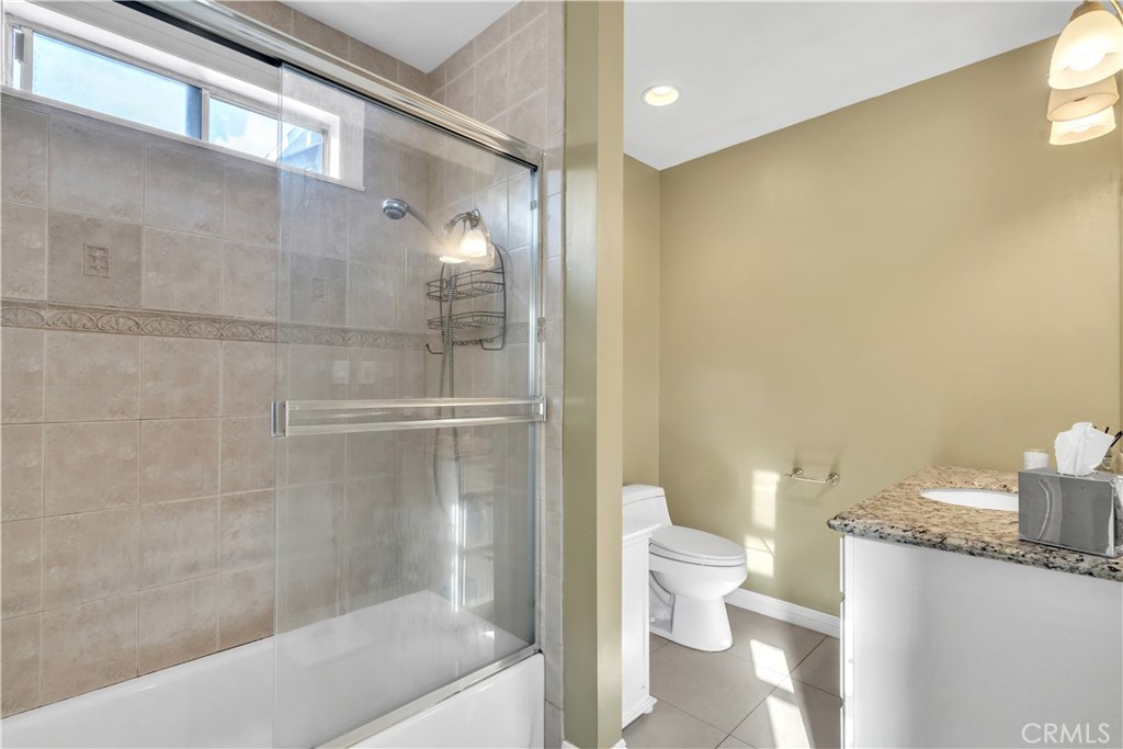 630 King Street Monrovia, CA 91016 - Photo 9 of 22 a bathroom with a granite countertop bathtub shower and toilet