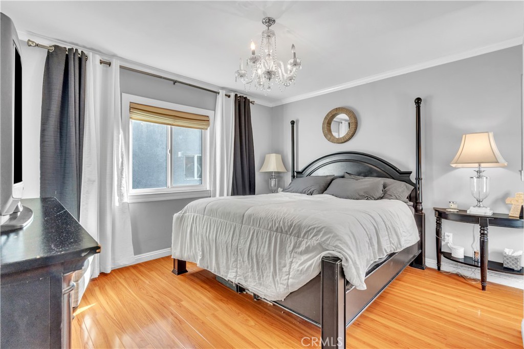 630 King Street Monrovia, CA 91016 - Photo 10 of 22 a bedroom with a bed and a chandelier