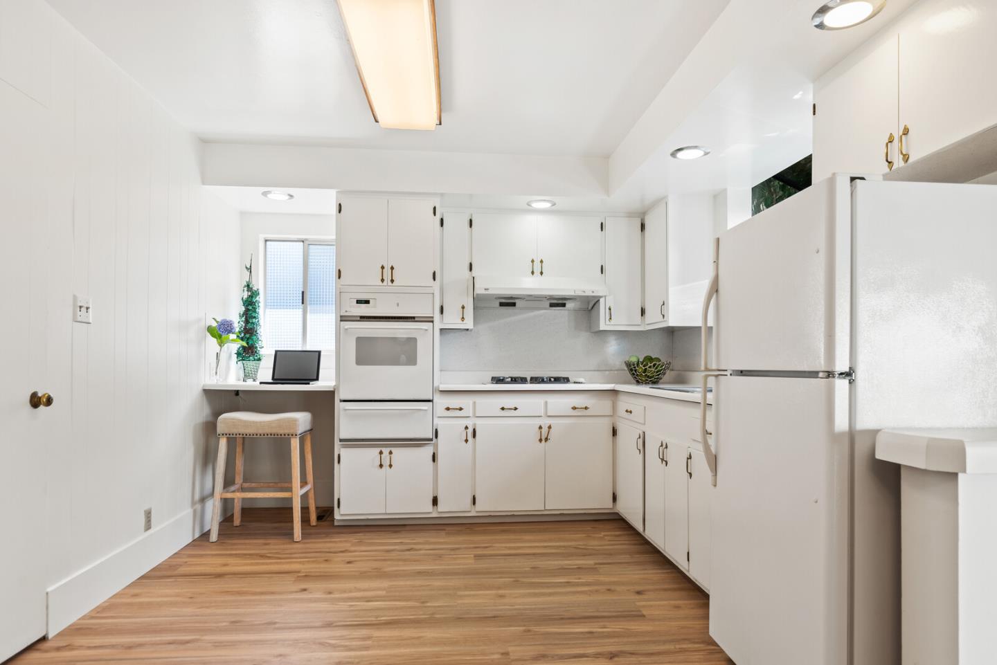 225 Victoria Road Burlingame, CA 94010 - Photo 11 of 29 a kitchen with white cabinets and white appliances