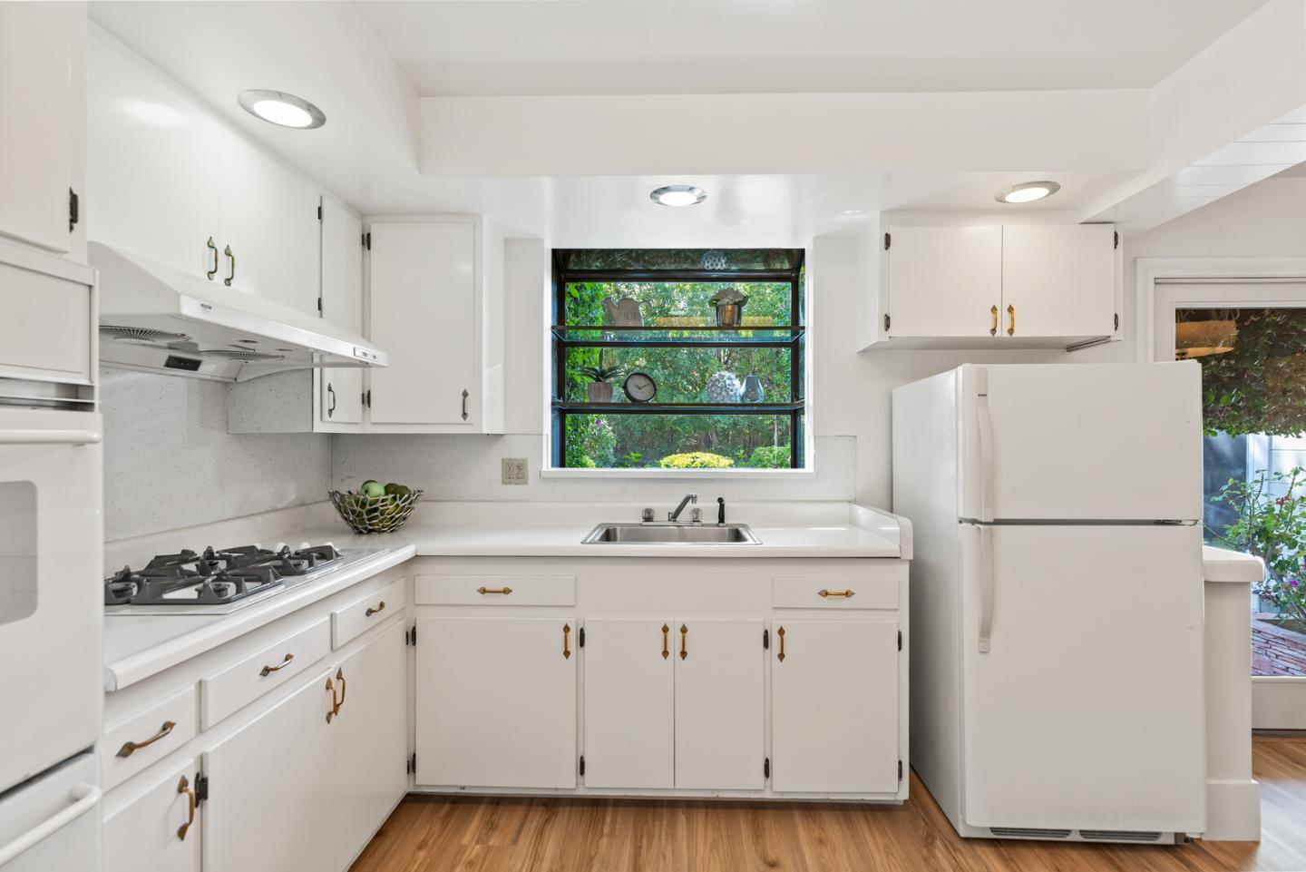 225 Victoria Road Burlingame, CA 94010 - Photo 13 of 29 a kitchen with white cabinets and white appliances