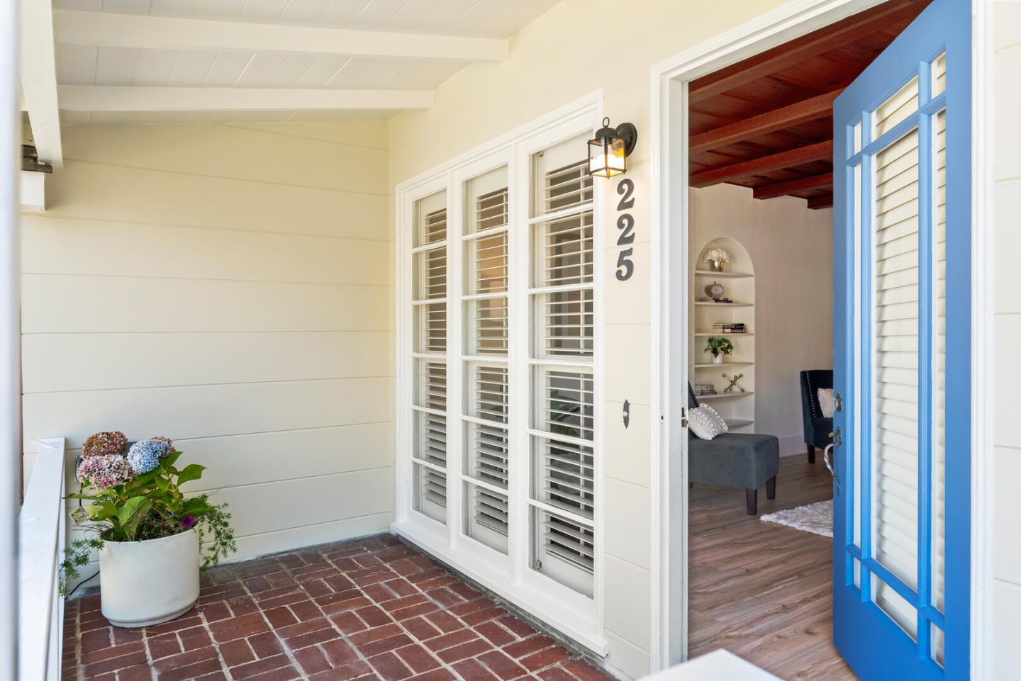 225 Victoria Road Burlingame, CA 94010 - Photo 4 of 29 a view of a hallway with wooden cabinet and a potted plant